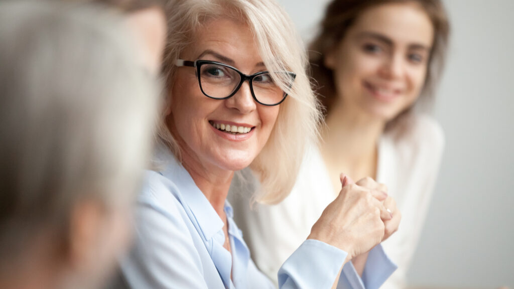 A businesswoman smiling with colleagues.