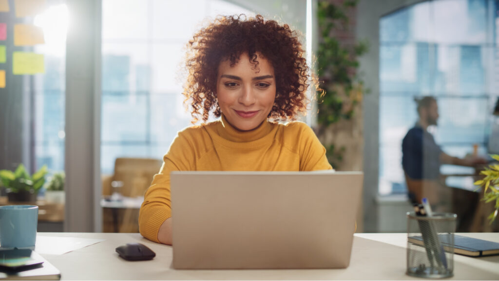 A woman using a laptop.