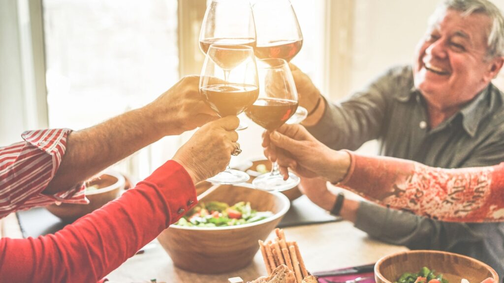 A group of friends cheering with wine.