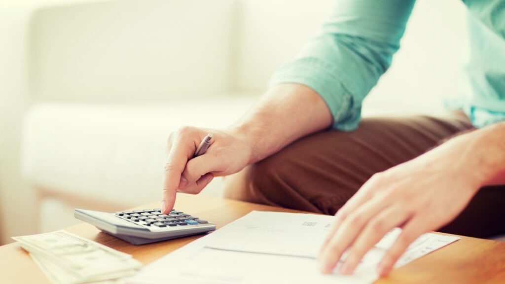 A man using a calculator.