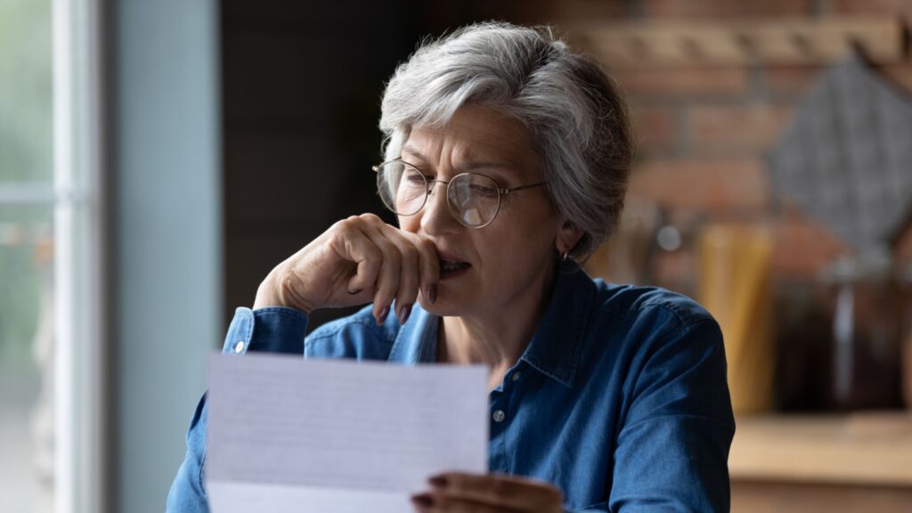 A woman reading a letter.