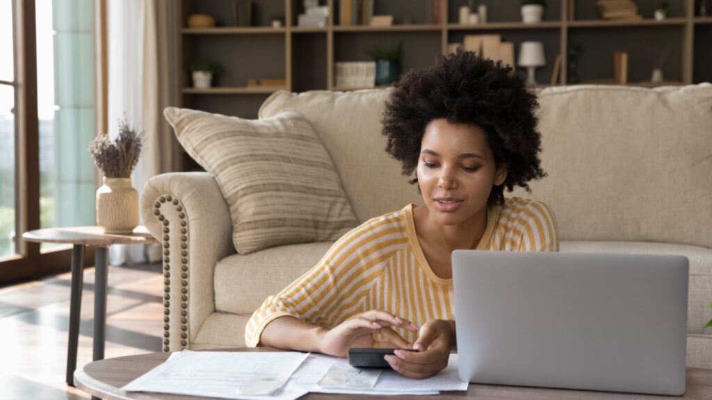 A woman reviewing some paperwork at home.