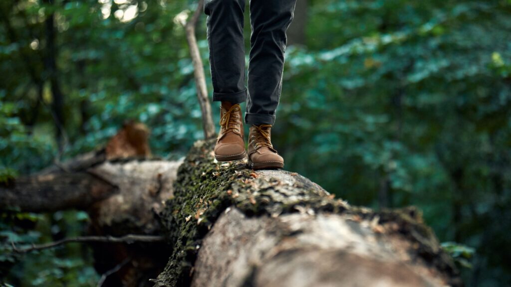 A man walking on a log.