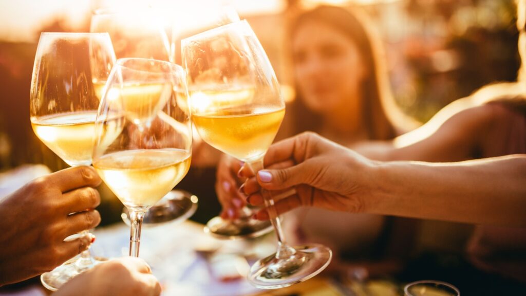 A group of friends clinking wine glasses.