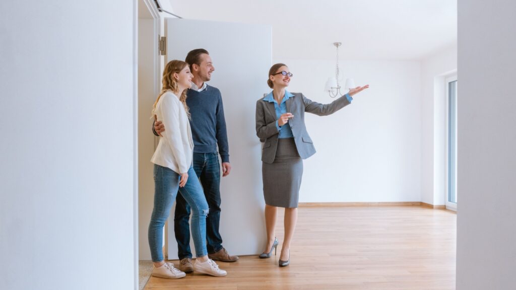 An estate agent showing a couple a property.