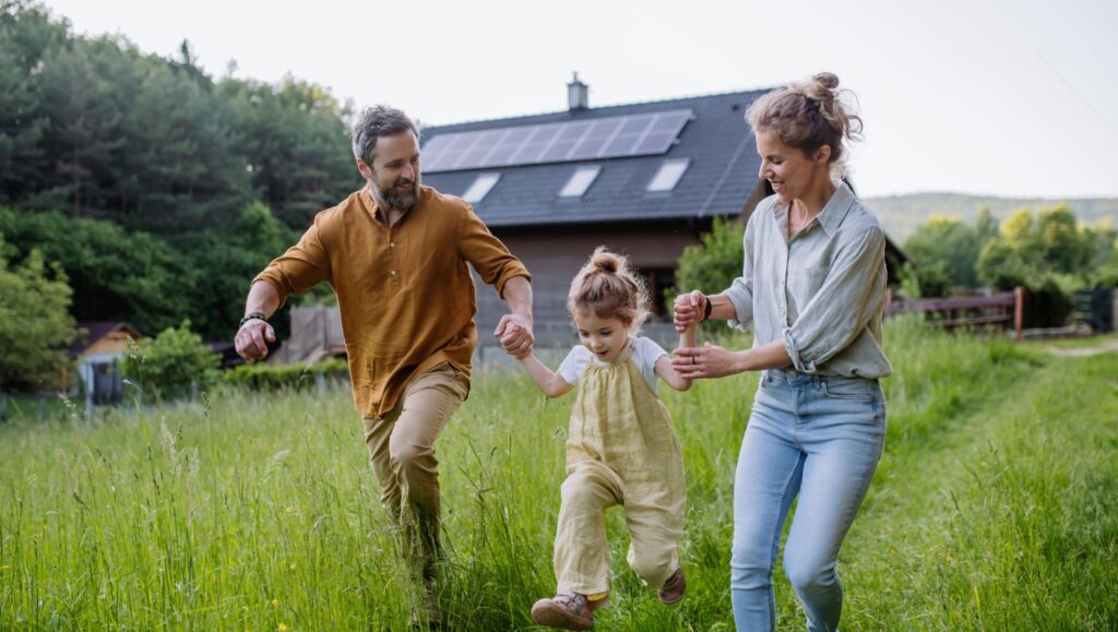 A young family playing in a garden.