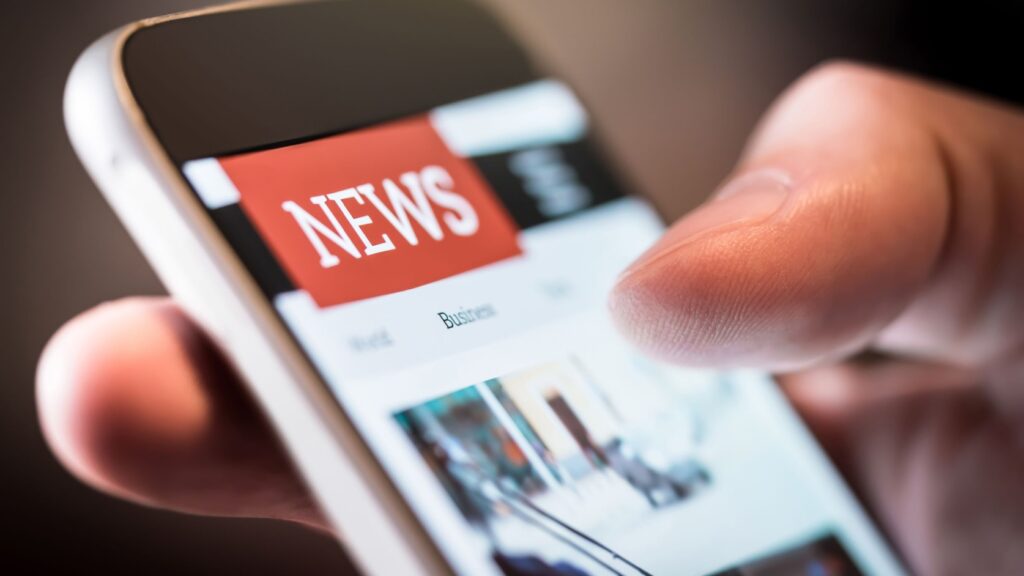 A person using a smartphone to read the news.