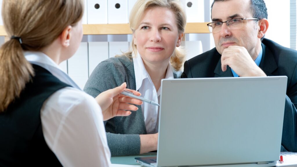 A couple talking to a financial planner.