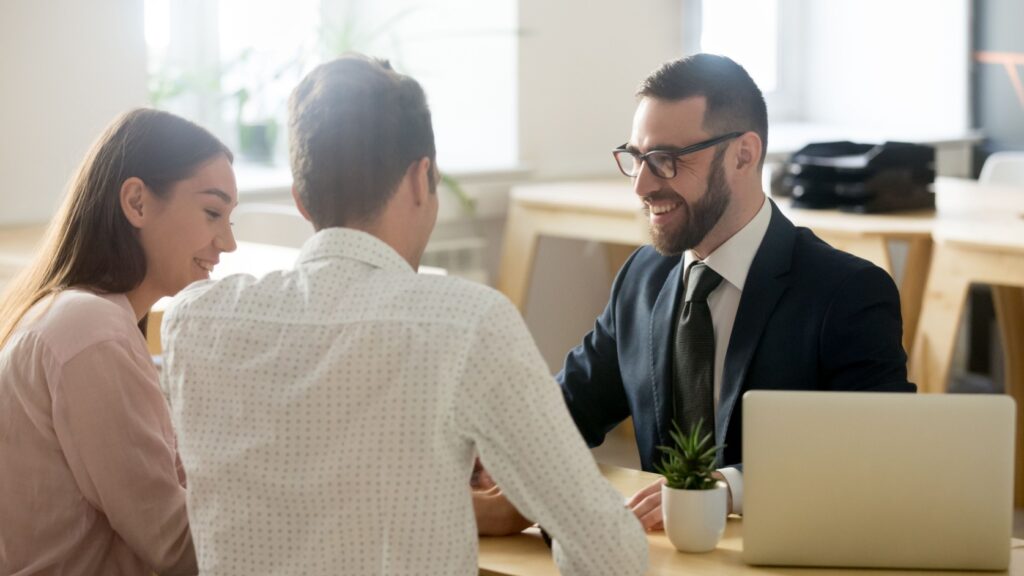 A young couple meeting with a financial planner.