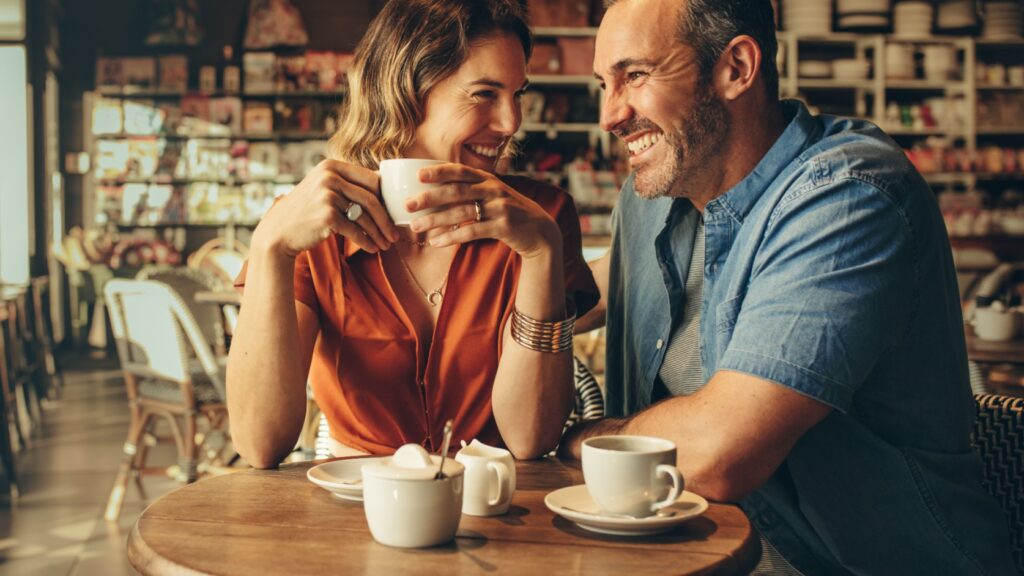 A couple laughing in a café.