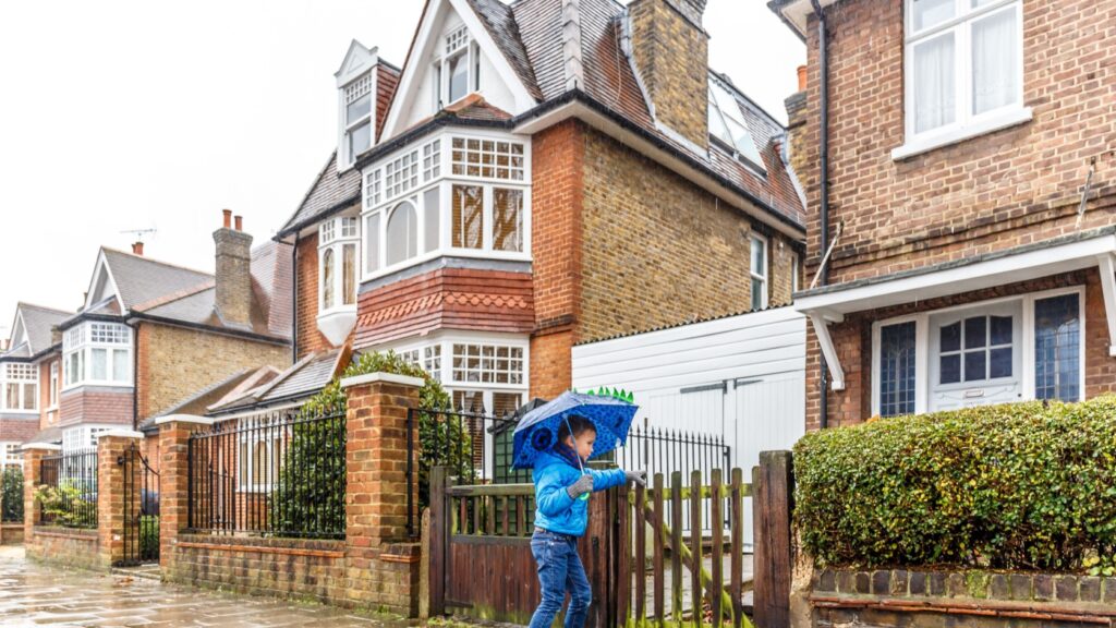 A young by walking down a UK street.