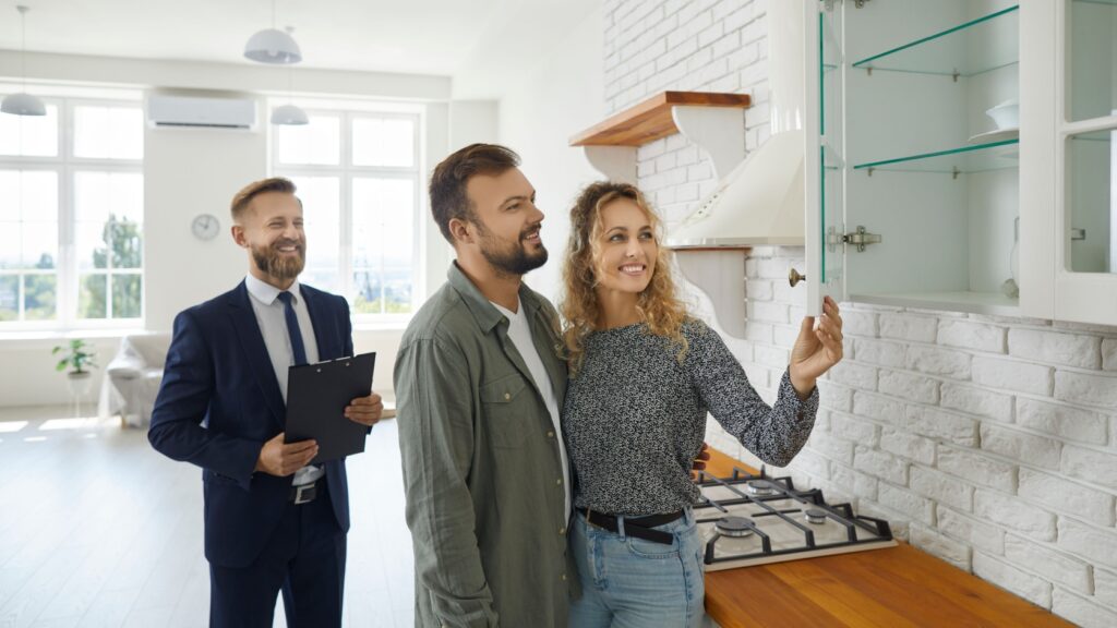 A couple viewing a property with an estate agent.