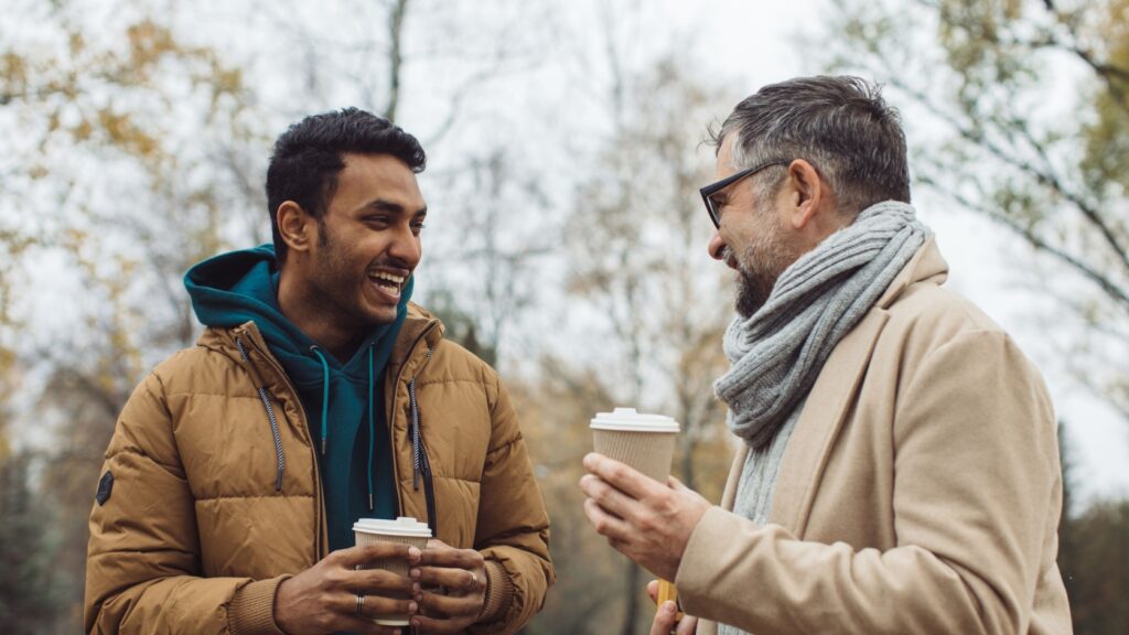 Two men talking together outdoors.