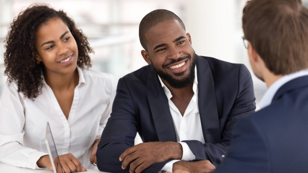 A couple taking to a financial planner.