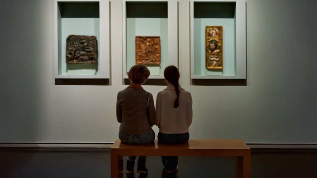 Two people looking at art in a gallery.