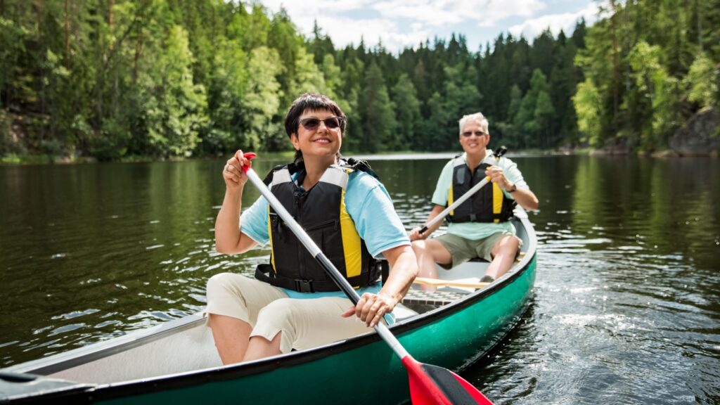 A couple on holiday taking a canoe ride.