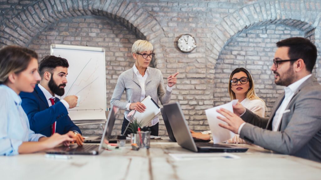 A group of colleagues sitting around a conference table.