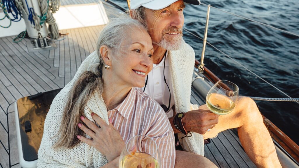 A couple sitting on a yacht deck.