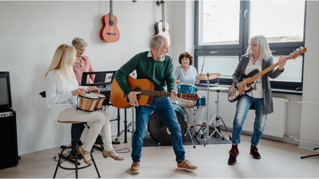A group of people in their 50s playing musical instruments in a band.
