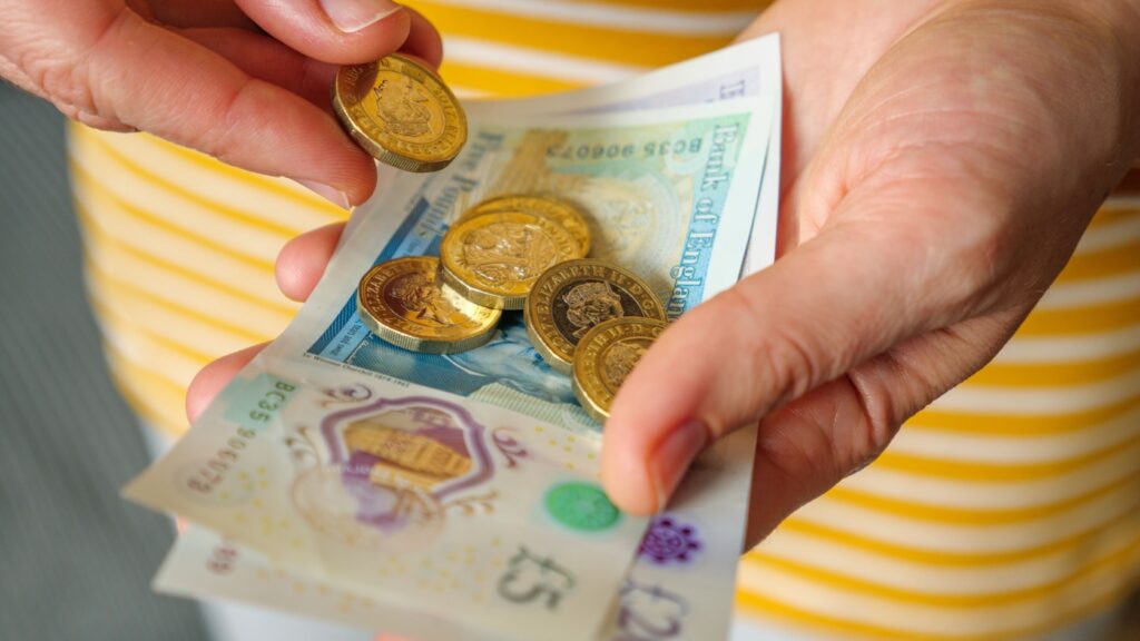 A woman holding cash in her hands.