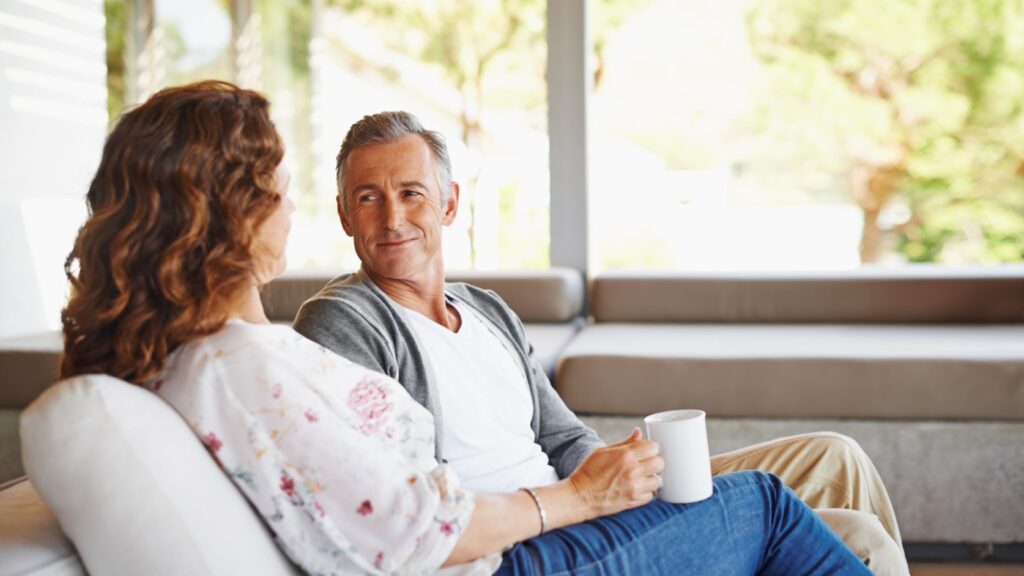 A couple talking in their home.