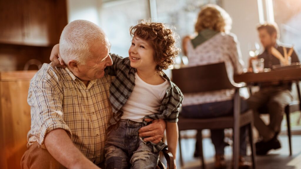 Grandfather hugging his grandchild.