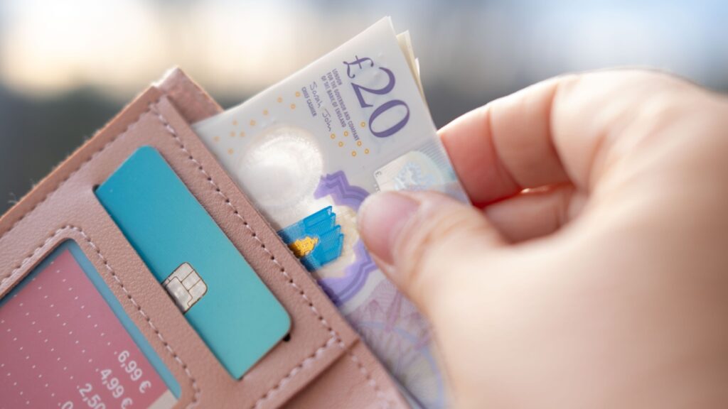 Someone taking money out of a wallet.