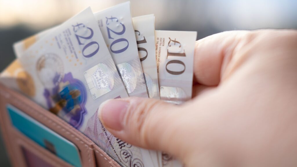 Someone taking money out of a wallet